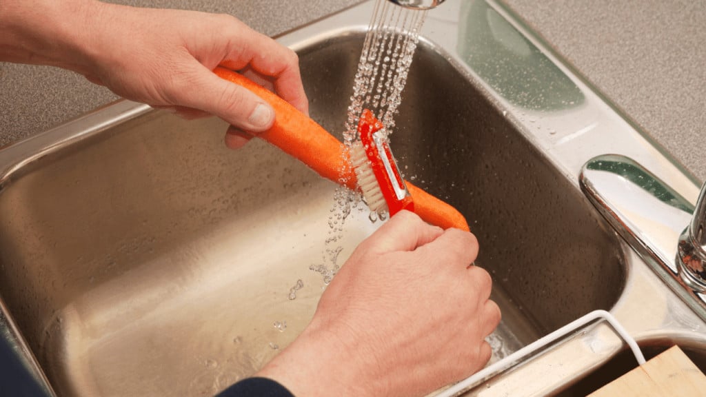 Clean carrots using a bristle