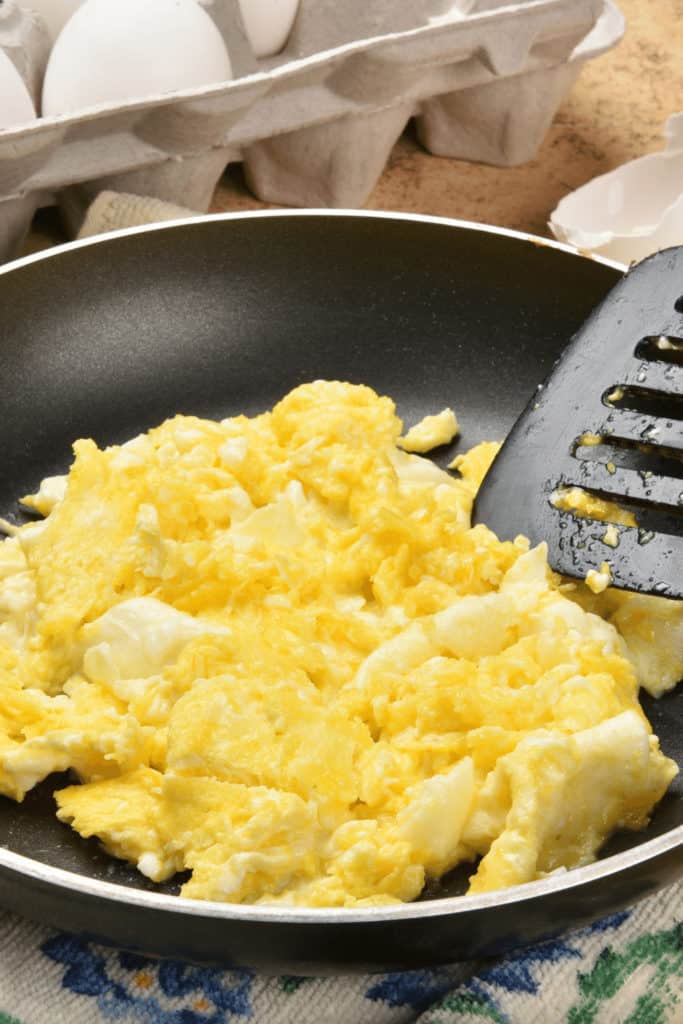 Scrambled eggs are done when the curds thicken