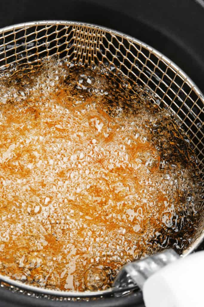 The boiling point of vegetable oil is  575° Fahrenheit (302° Celsius)