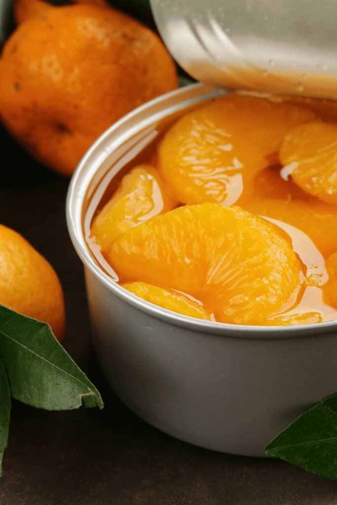 You risk a food-borne illness when eating canned mandarines with white spots on them