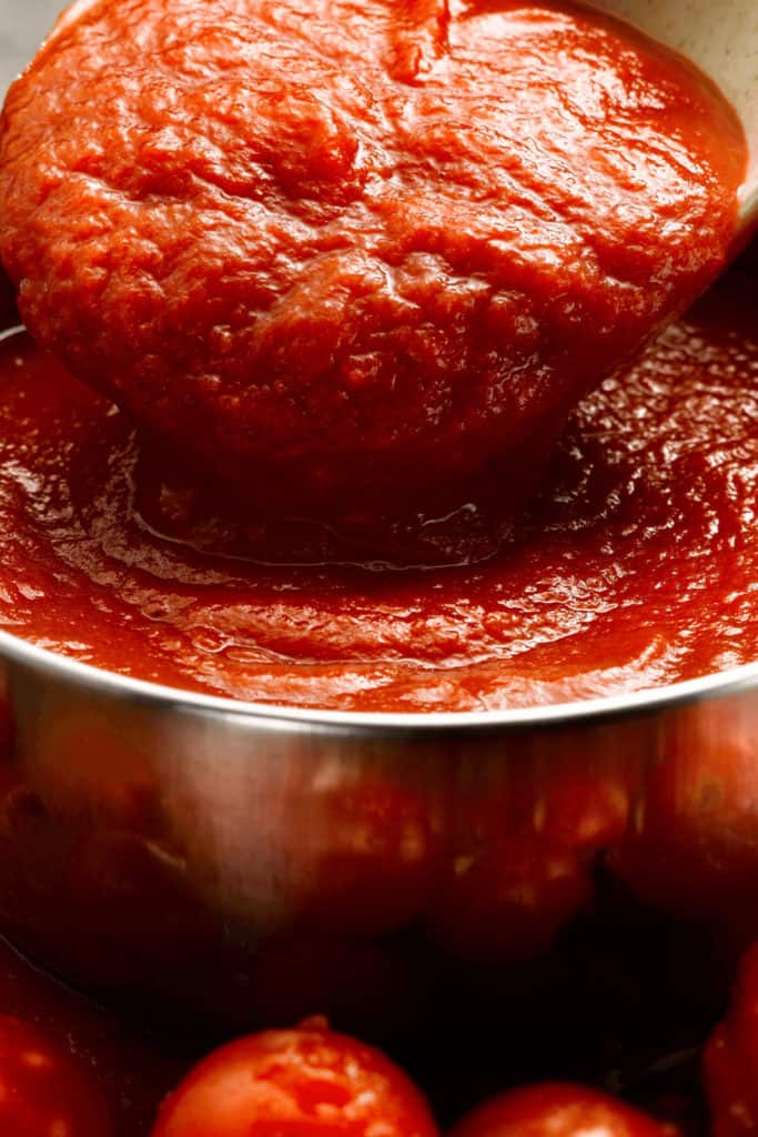 Mold has micro-roots and spores that can also be in the un-moldy part of tomato sauce