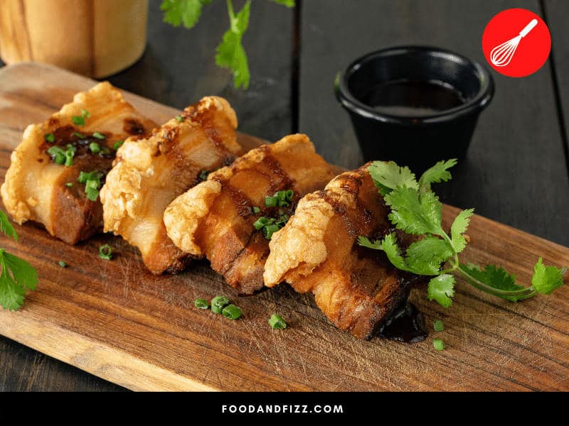 A dish like Crispy Pork Belly may be finished by broiling to ensure that the skin is as crispy as possible before serving. Broiling takes place at very high temperatures and makes it easy to achieve this level of crispiness.