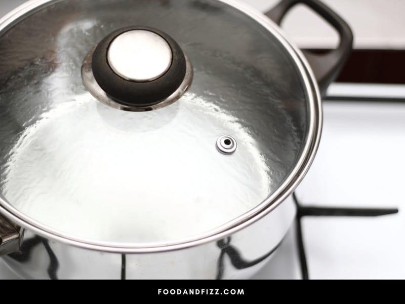 Boiling Water with the Lid On Limits Evaporation, Constrains Heat and Increases Pressure, Thereby Causing Water to Boil Faster.