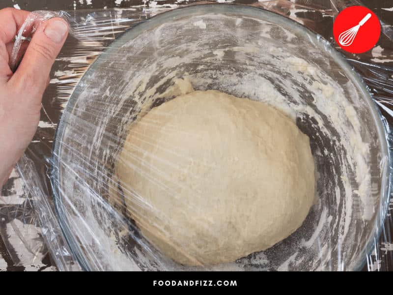 Plastic wrap is the best cover for dough as it traps moisture and ensures dough will rise beautifully.