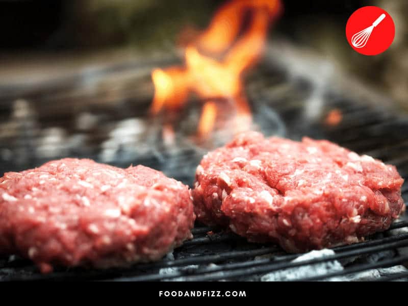 Uncooked burger patties will always be red or pink because of what's called "myoglobin". When exposed to high heat, a chemical reaction occurs causing your burgers to turn brown as it cooks.