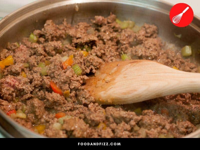 To ensure even cooking of ground beef, spread the beef around the pan and do not stir too much until a crusty layer is formed.