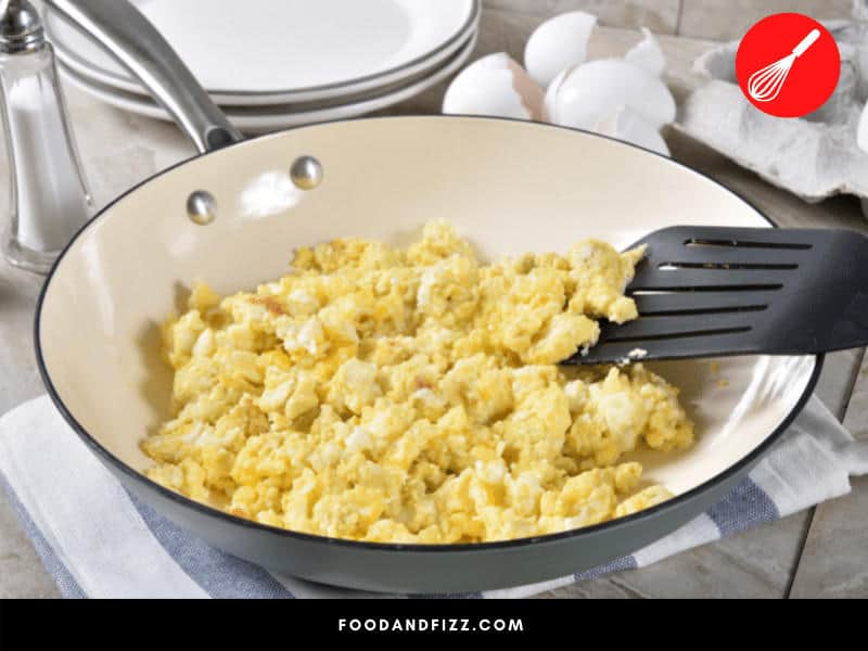 Overcooking scrambled eggs can cause them to turn grey. They are still safe to eat, even if they look a bit unappetizing.