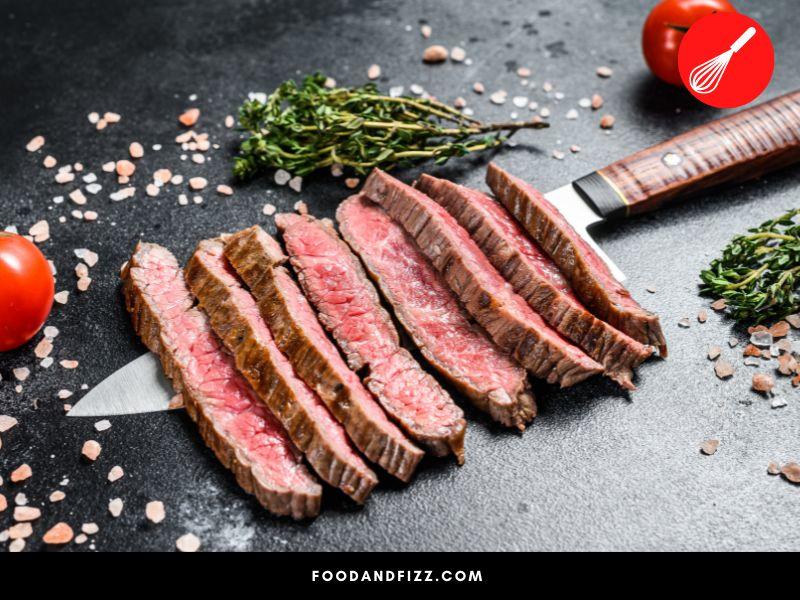 Bacteria thrive on the meat surface therefore the inside of the steak is relatively safe. Ground beef has more surface area for bacteria to proliferate.