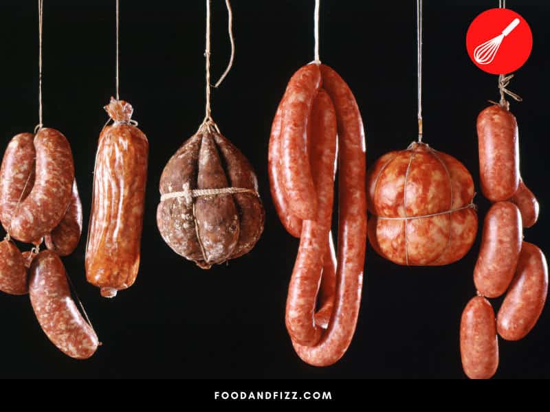 Sausage is cured and hung up to dry for six weeks, with the help of added curing agents.