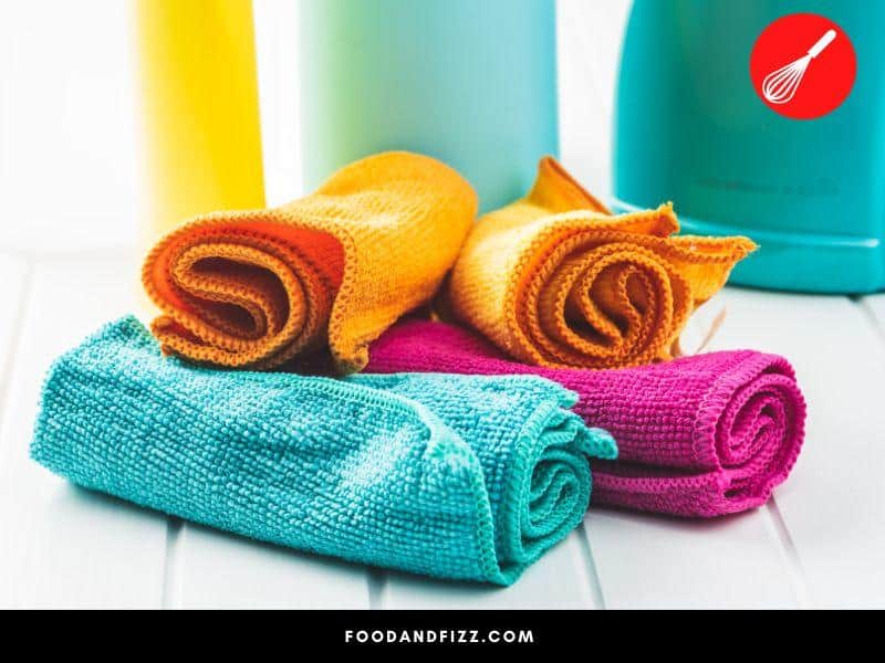 Microfiber cloths are a reusable, more eco-friendly alternative to paper towels for cleaning spills in the kitchen.