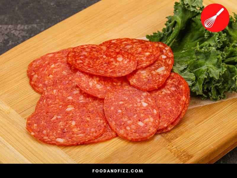 Raw pepperoni is spicy, salty and tangy.