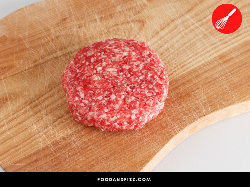 White spots on hamburger meat can be due to fat, freezer burn or food spoilage.