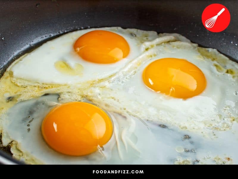 When heat is applied to eggs, the proteins in the egg whites denature and transform into a different type of protein, changing the color and texture of the egg whites.