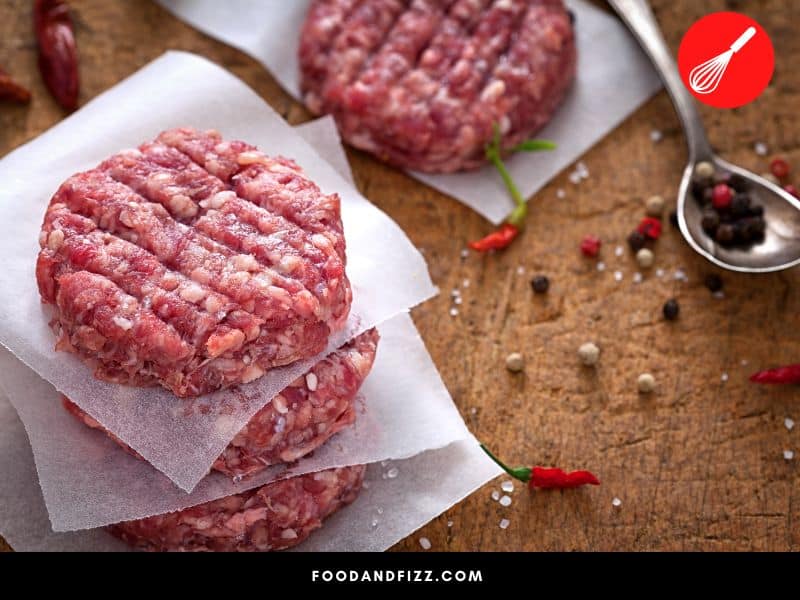 White stuff on burger patties may be due to fat and other beef parts, freezer burn or may be due to food spoilage.