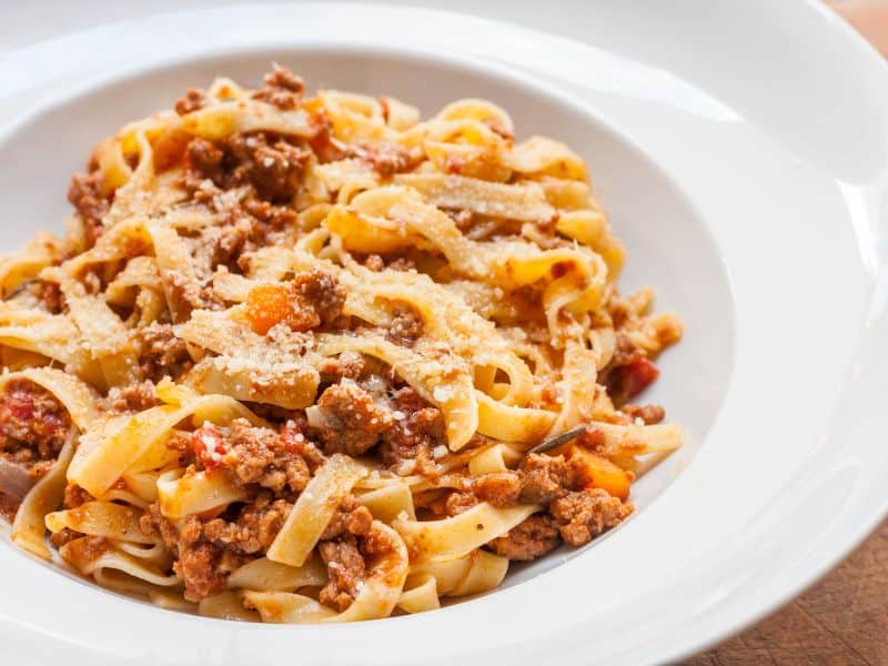 Ragu Alla Bolognese is braised and slow cooked for hours, and is usually served with thick pasta like tagliatelle.