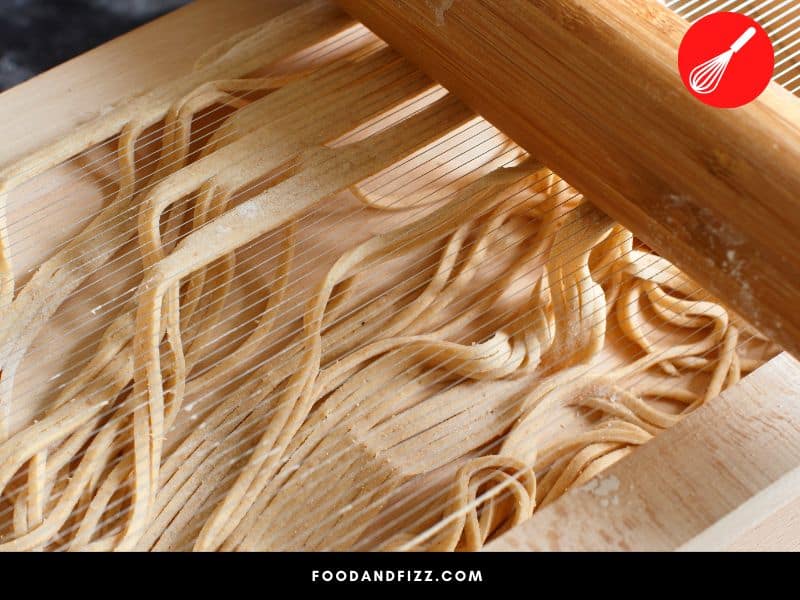A stringed wooden block called a chitarra is what is used to cut Spaghetti alla Chitarra into squarish strips.